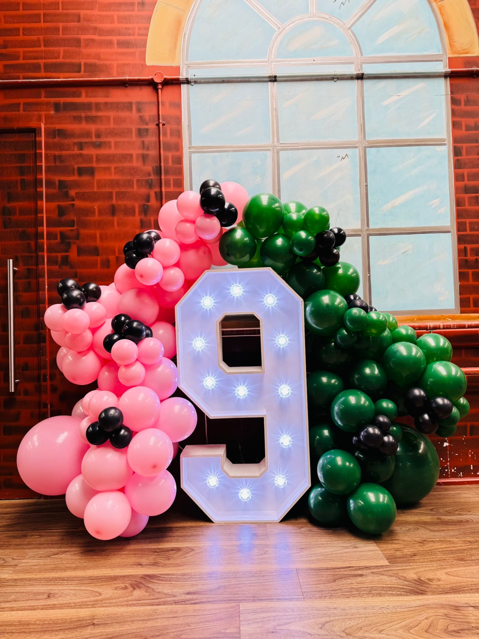 Number 9 display styled in pink and green