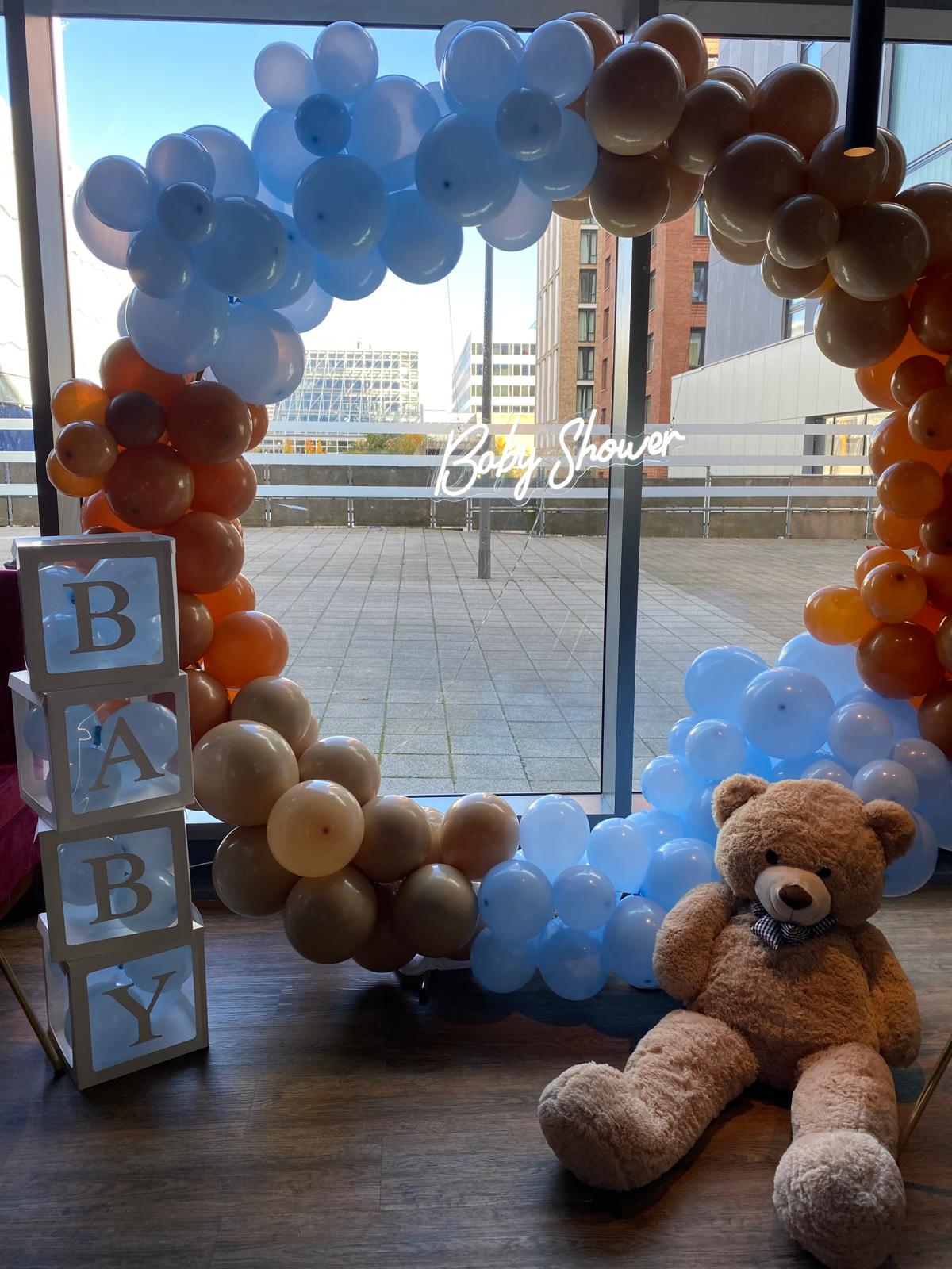 Baby shower balloon and floral setup with pastel decorations