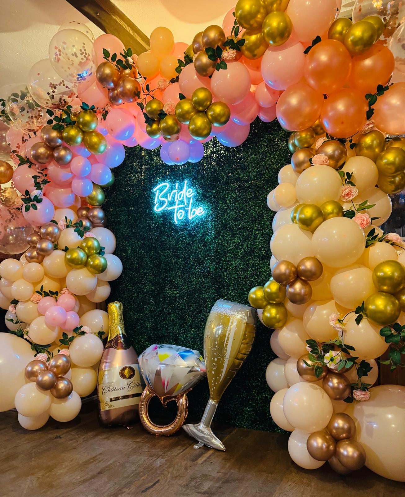 Engagement party balloon display with romantic tones
