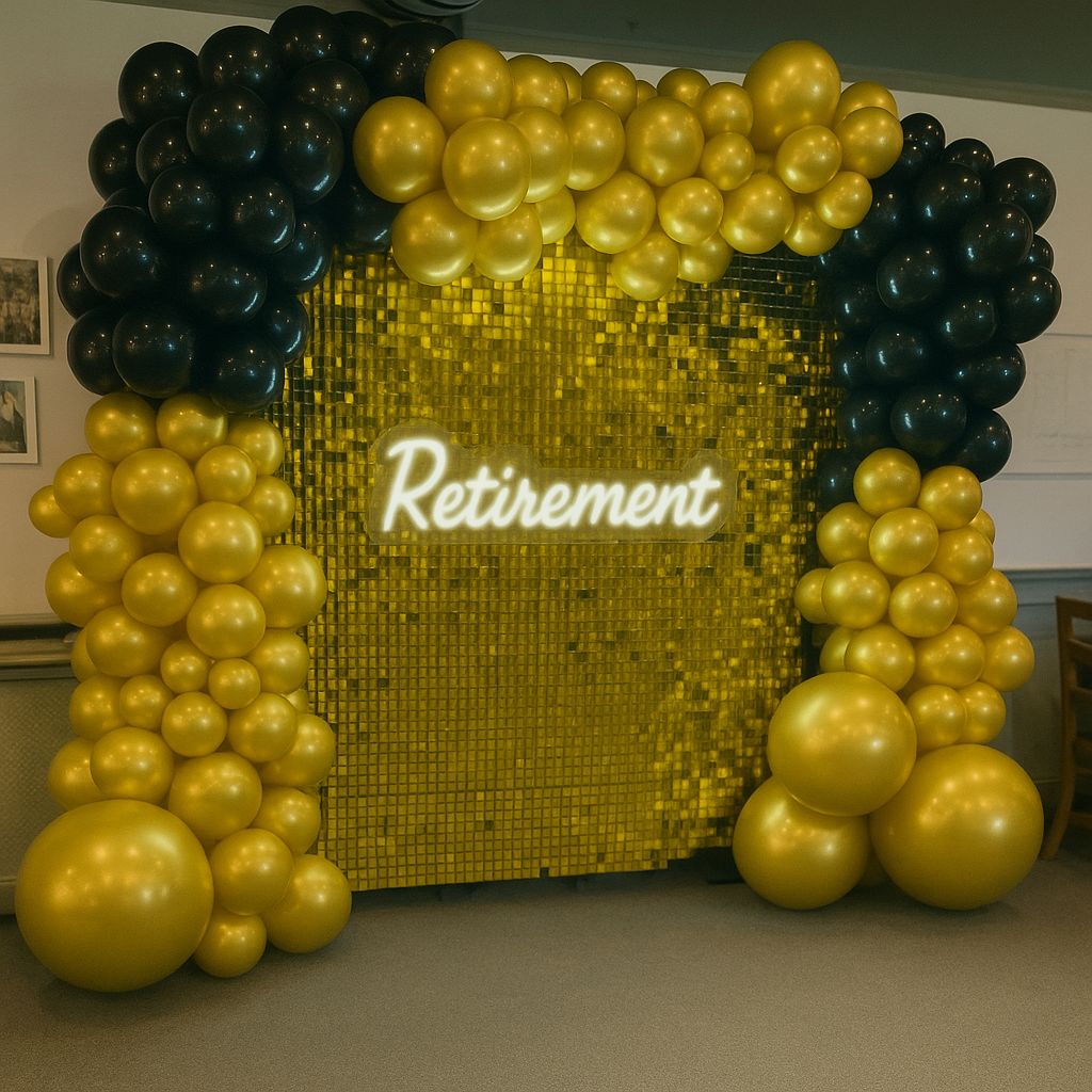 Retirement celebration backdrop with balloons and florals